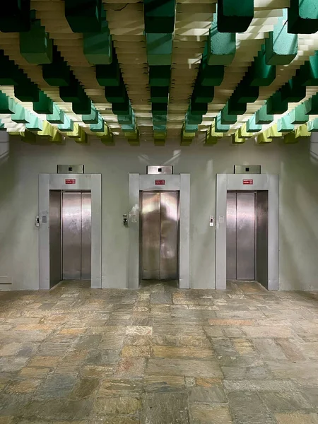 Three Elevators and a Ceiling Light