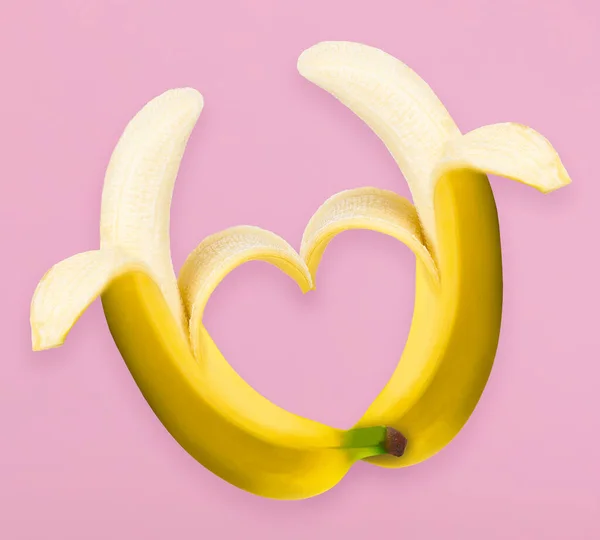 Love fruits, Two peeled bananas arranged together in shape of heart representing couple in love