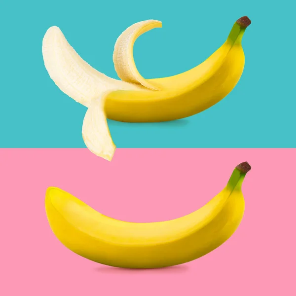 Creative layout made of closed and open banana on pink and blue background