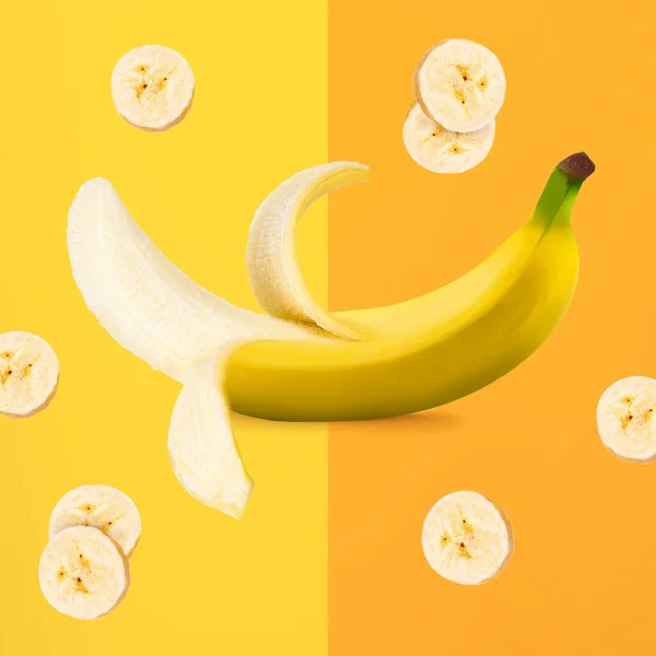 Ripe banana with banana slices isolated on yellow and orange background