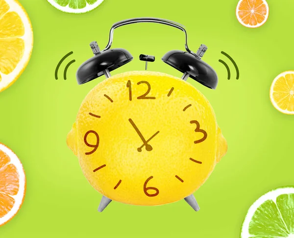 Creative concept of lemon with alarm clock elements on green background, summer time concept