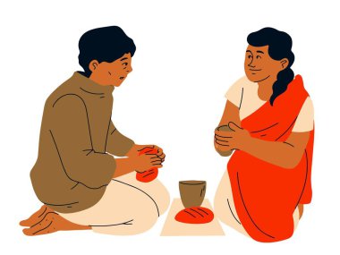 Hintli çift bir fincan kahve tutuyor. 