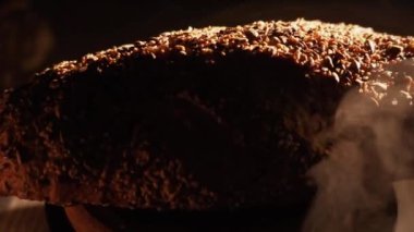 Fresh Sliced Black Rye Bread on A Tray, Close up. Slices of Healthy Black Bread for Breakfast for Toast and Sandwiches. Healthy Vegan Food