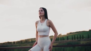 Young woman practicing yoga on the nature at sunset. active meditation a relax concept