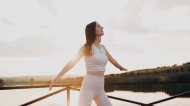 Young woman practicing yoga on the nature at sunset. active meditation a relax concept