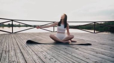 Young woman practicing yoga on the nature at sunset. active meditation a relax concept