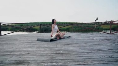 Young woman practicing yoga on the nature at sunset. active meditation a relax concept