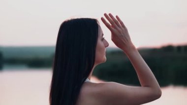Young woman practicing yoga on the nature at sunset. active meditation a relax concept