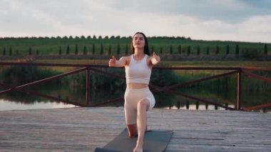 Young woman practicing yoga on the nature at sunset. active meditation a relax concept