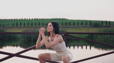 Young woman practicing yoga on the nature at sunset. active meditation a relax concept