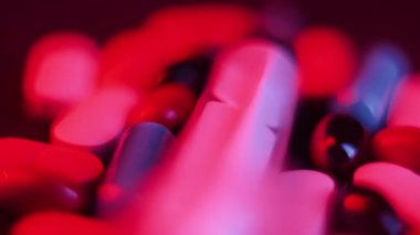 Pills and a syringe with a drug revolve on a black background. the concept of drug addiction, banditry and criminal case