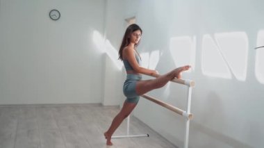 Attractive sexy girl doing sports and flying in air on stretch fabric Airo stretching or fly yoga. Active healthy lifestyle. 