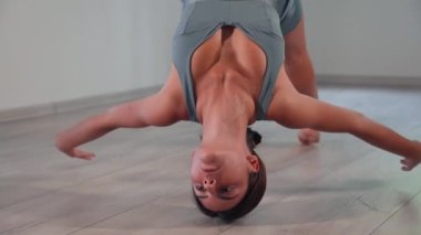 Attractive sexy girl doing sports and flying in air on stretch fabric Airo stretching or fly yoga. Active healthy lifestyle. 