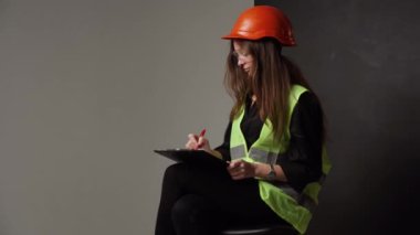 Construction worker. Woman engineer on white background in studio