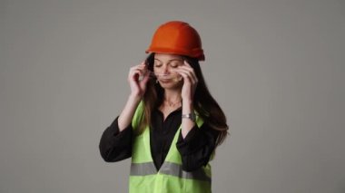 Construction worker. Woman engineer on white background in studio