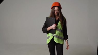 Construction worker. Woman engineer on white background in studio