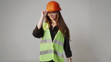 Construction worker. Woman engineer on white background in studio