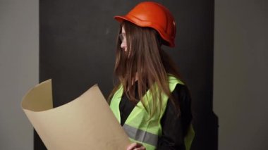 Construction worker. Woman engineer on white background in studio