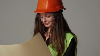 Construction worker. Woman engineer on white background in studio