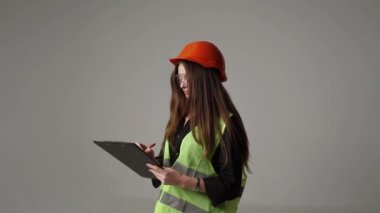Construction worker. Woman engineer on white background in studio