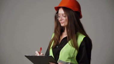 Construction worker. Woman engineer on white background in studio