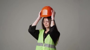 Construction worker. Woman engineer on white background in studio