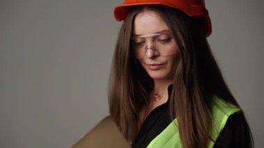 Construction worker. Woman engineer on white background in studio