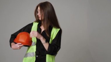 Construction worker. Woman engineer on white background in studio