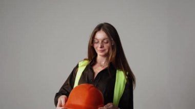 Construction worker. Woman engineer on white background in studio