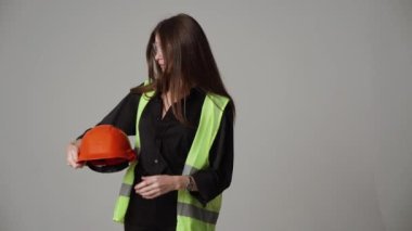 Construction worker. Woman engineer on white background in studio