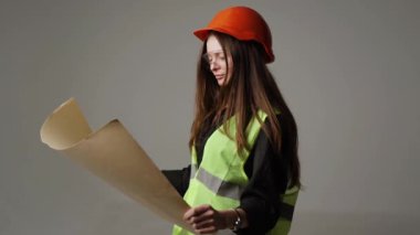 Construction worker. Woman engineer on white background in studio
