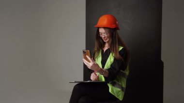 Construction worker. Woman engineer on white background in studio