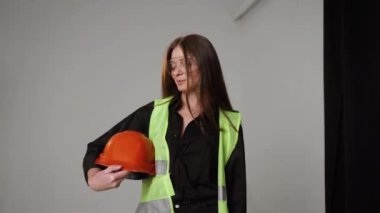 Construction worker. Woman engineer on white background in studio