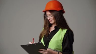 Construction worker. Woman engineer on white background in studio
