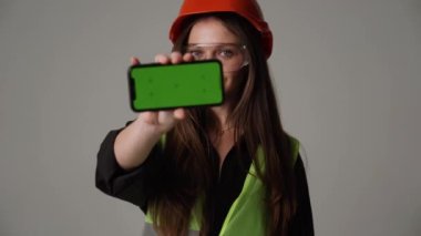 woman engineer holding green screen phone 4k