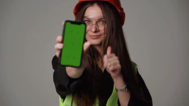woman engineer holding green screen phone 4k