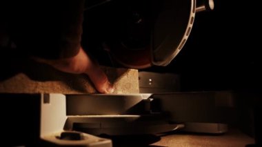 Worker in the carpentry workshop cuts the log into boards using band saw. Joinery. Raw wood Wooden crafts. Work at the factory 4k