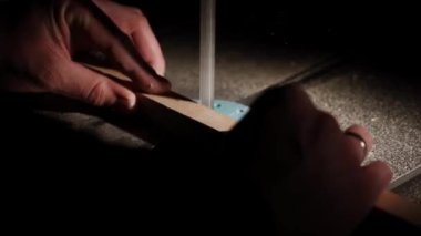 Worker in the carpentry workshop cuts the log into boards using band saw. Joinery. Raw wood Wooden crafts. Work at the factory 4k