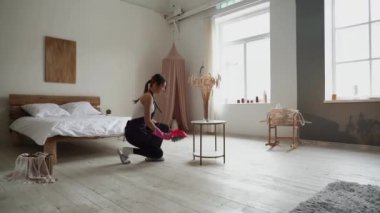 Cleaning service woman worker cleaning in living room at home. Beautiful young girl housekeeper cleaner wear apron and vacuuming messy dirty floor for housekeeping housework.Cleaning company concept