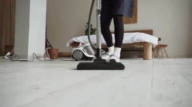 Cleaning service woman worker cleaning in living room at home. Beautiful young girl housekeeper cleaner wear apron and vacuuming messy dirty floor for housekeeping housework.Cleaning company concept