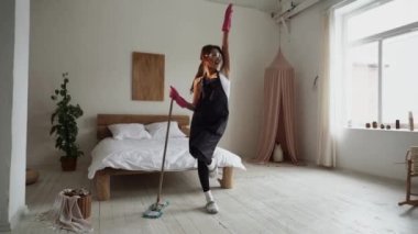 Cleaning service woman worker cleaning in living room at home. Beautiful young girl housekeeper cleaner wear apron and vacuuming messy dirty floor for housekeeping housework.Cleaning company concept