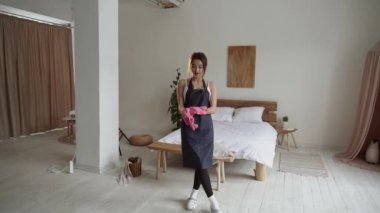 Cleaning service woman worker cleaning in living room at home. Beautiful young girl housekeeper cleaner wear apron and vacuuming messy dirty floor for housekeeping housework.Cleaning company concept