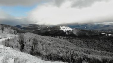 Sunny day in snow covered Carpathian Mountains. Clouds above clear sky 4k