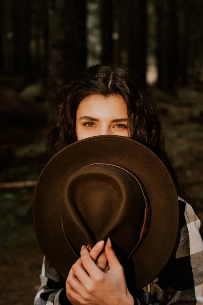 stock image Stylish hipster woman in a hat posing in a pine forest.Travel concept