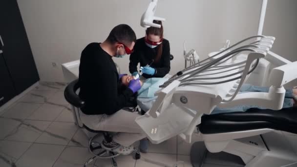 Two Doctors Man Woman Protective Masks Dental Clinic Serve Patient — Stock Video