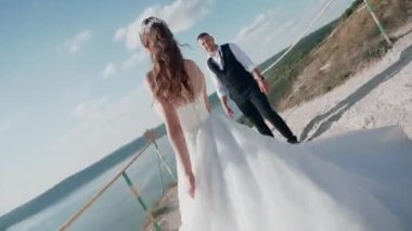 Genç çift kayanın kenarında duruyor. Sevgi. Balayı