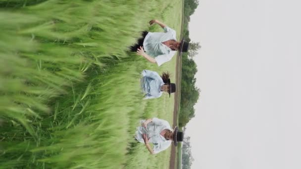 Zespół Trzech Młodych Tancerzy Kapeluszach Tańczy Bawi Się Zielonym Polu — Wideo stockowe