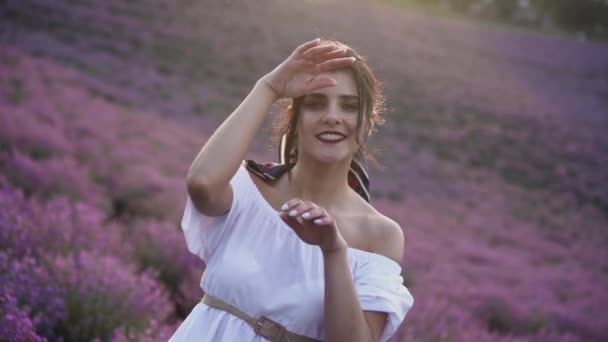 ラベンダー畑を歩く美しい女性花自然を愛する白いドレスおとぎ話の幸せコンセプト — ストック動画