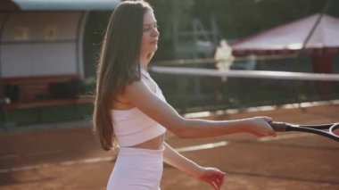 Kil spor sahasında tenis oynayan genç bir kadın. Tenis konsepti.