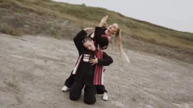 İki kadın çölde ustaca modern dans ediyor. Dans ve ritim kavramı